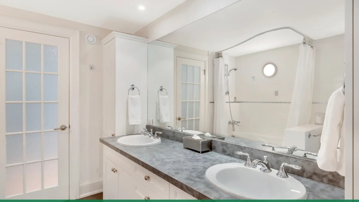 A fitted bathroom with bath, shower screen and vanity area